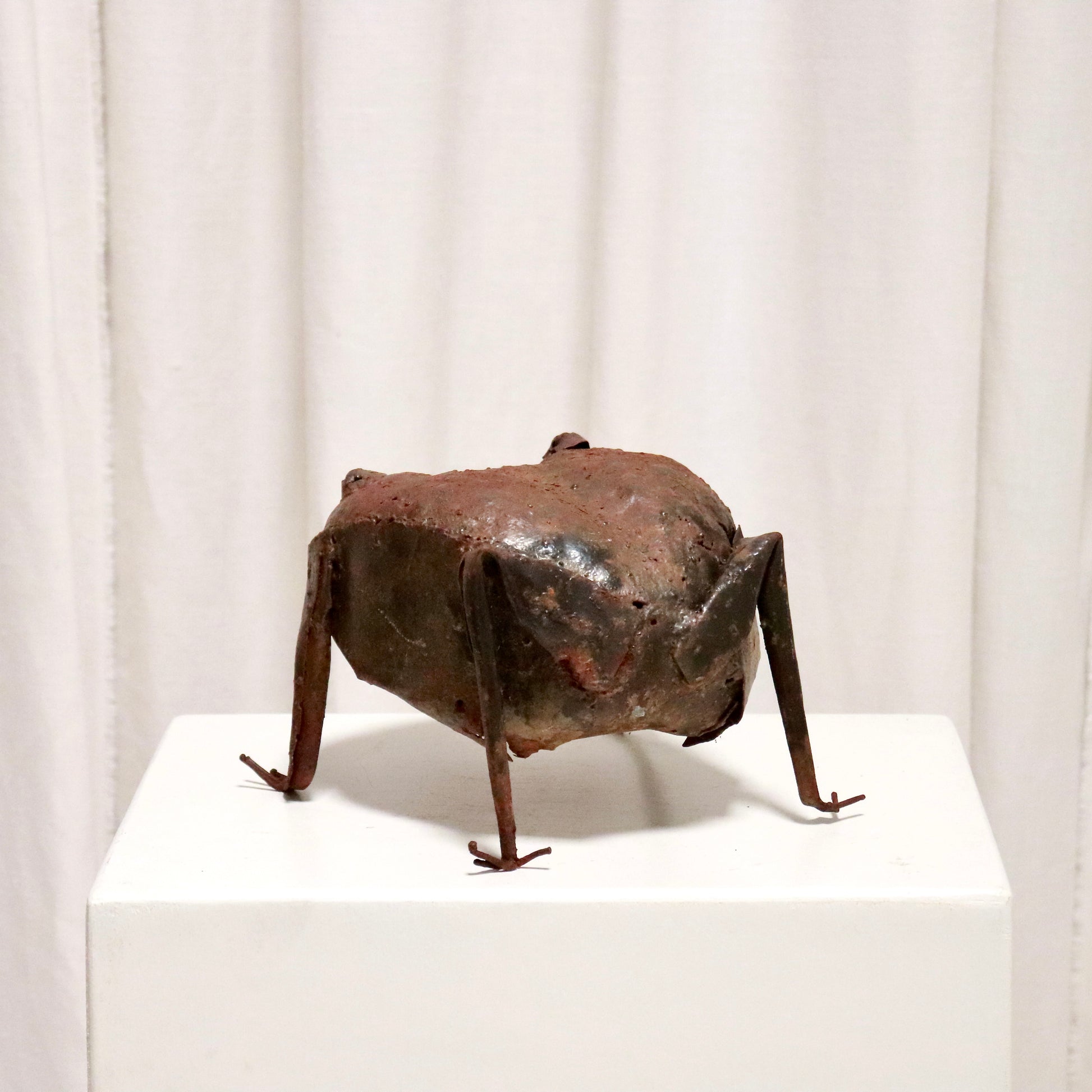 Rear view showing patchwork sheet-steel body.