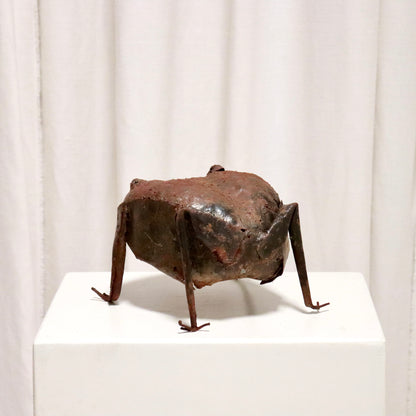 Rear view showing patchwork sheet-steel body.