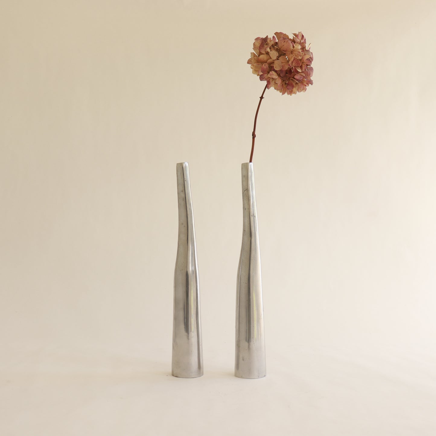 Pair of vintage cast aluminium vases tall form