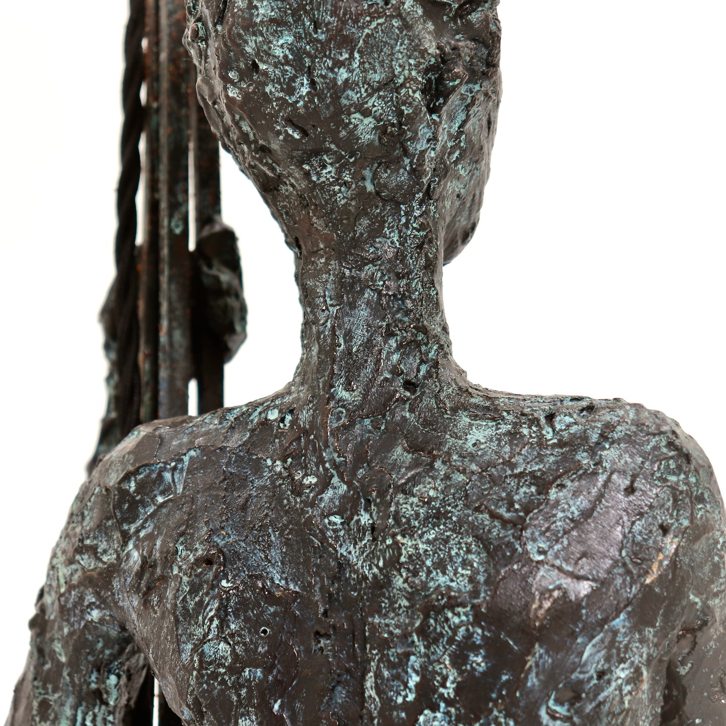 Close-up of sculpted figure holding lamp stem