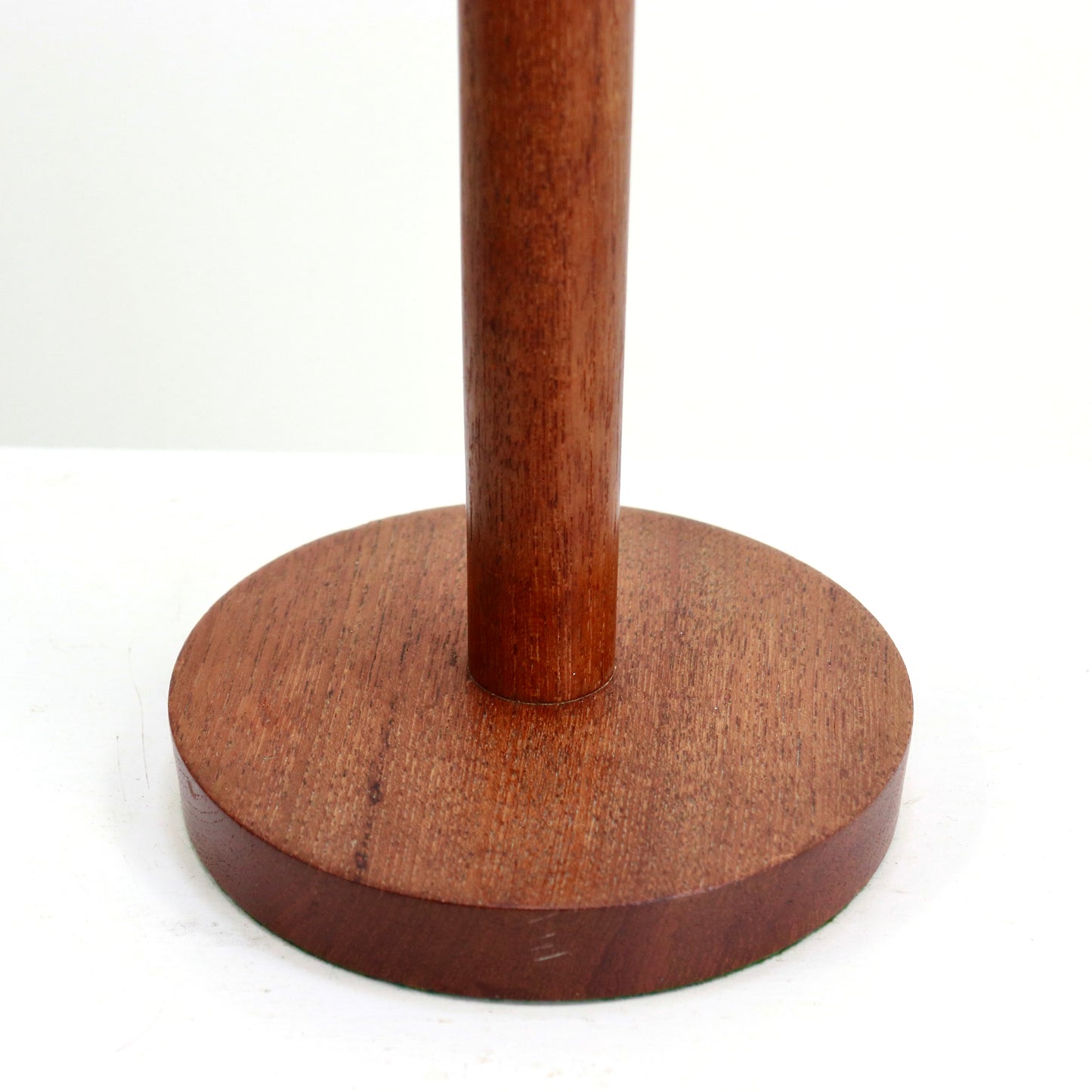 “Round teak base of mid-century table lamp, detail”