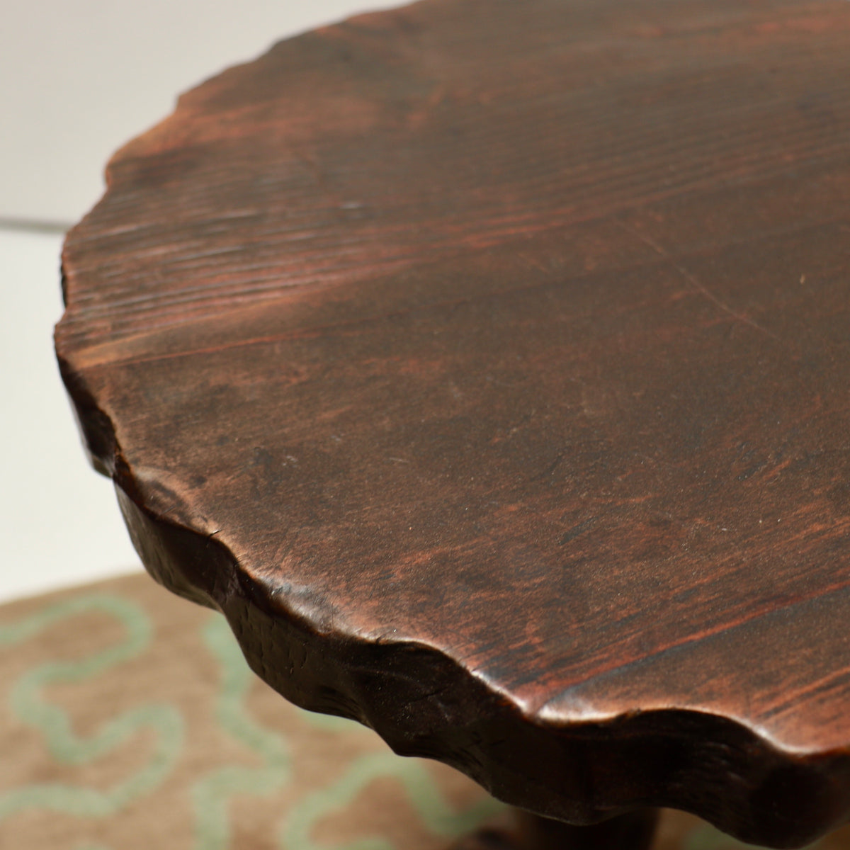 Detail of the dark wooden tabletop and wear to its finish