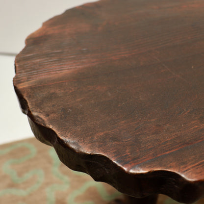 Detail of the dark wooden tabletop and wear to its finish
