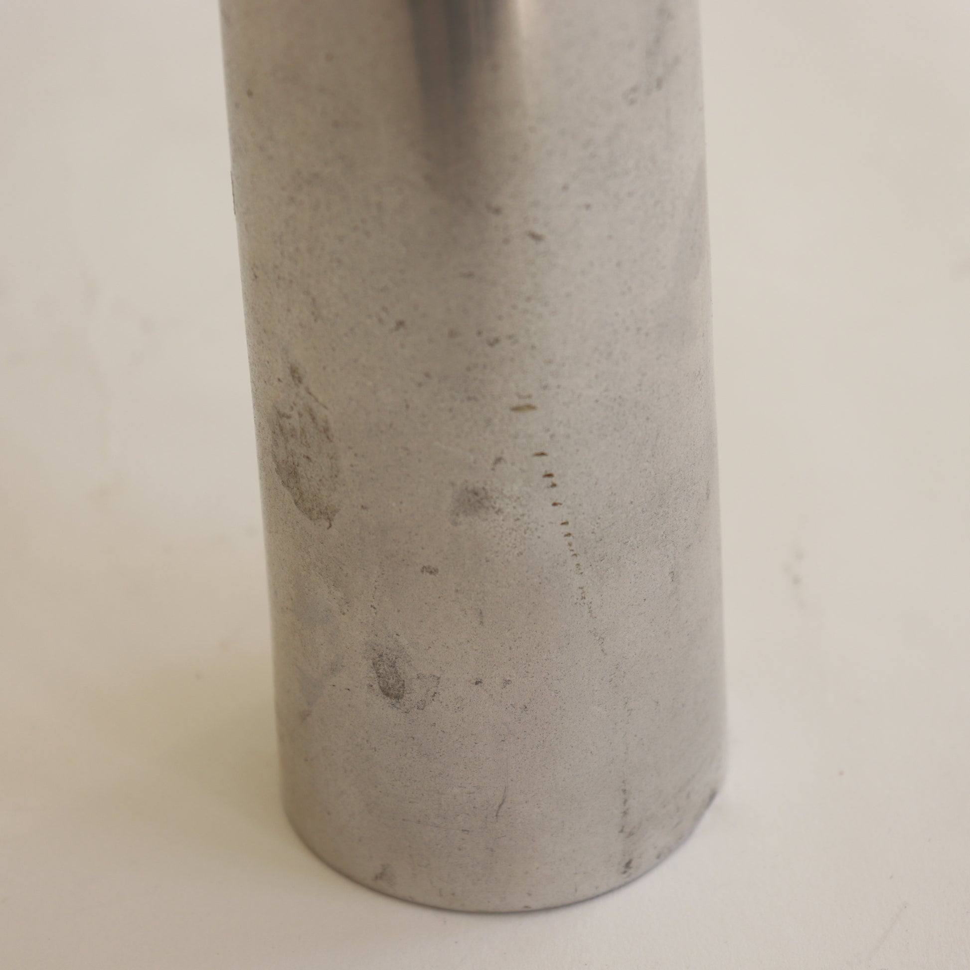 Aluminium vase detail with oxidation and wear