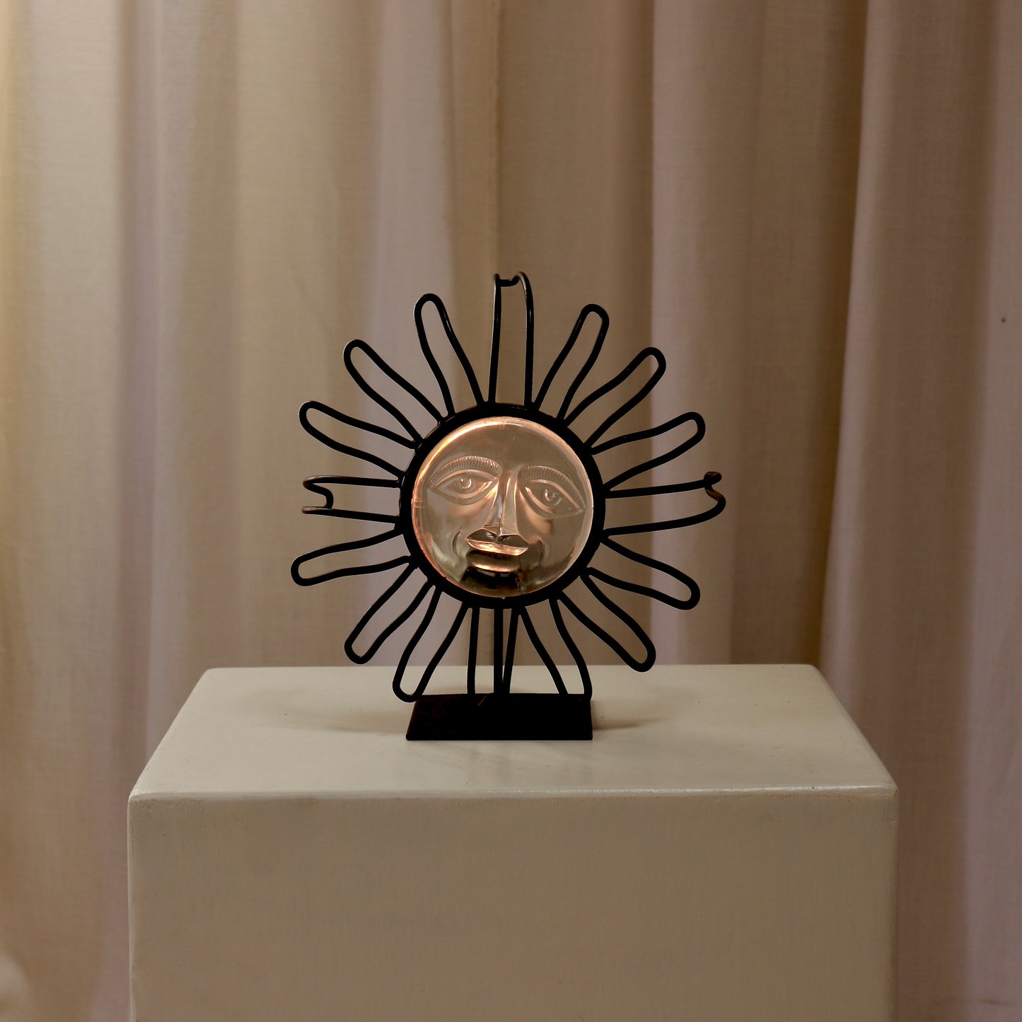 Candle-lit view showing the glass face glowing warm.