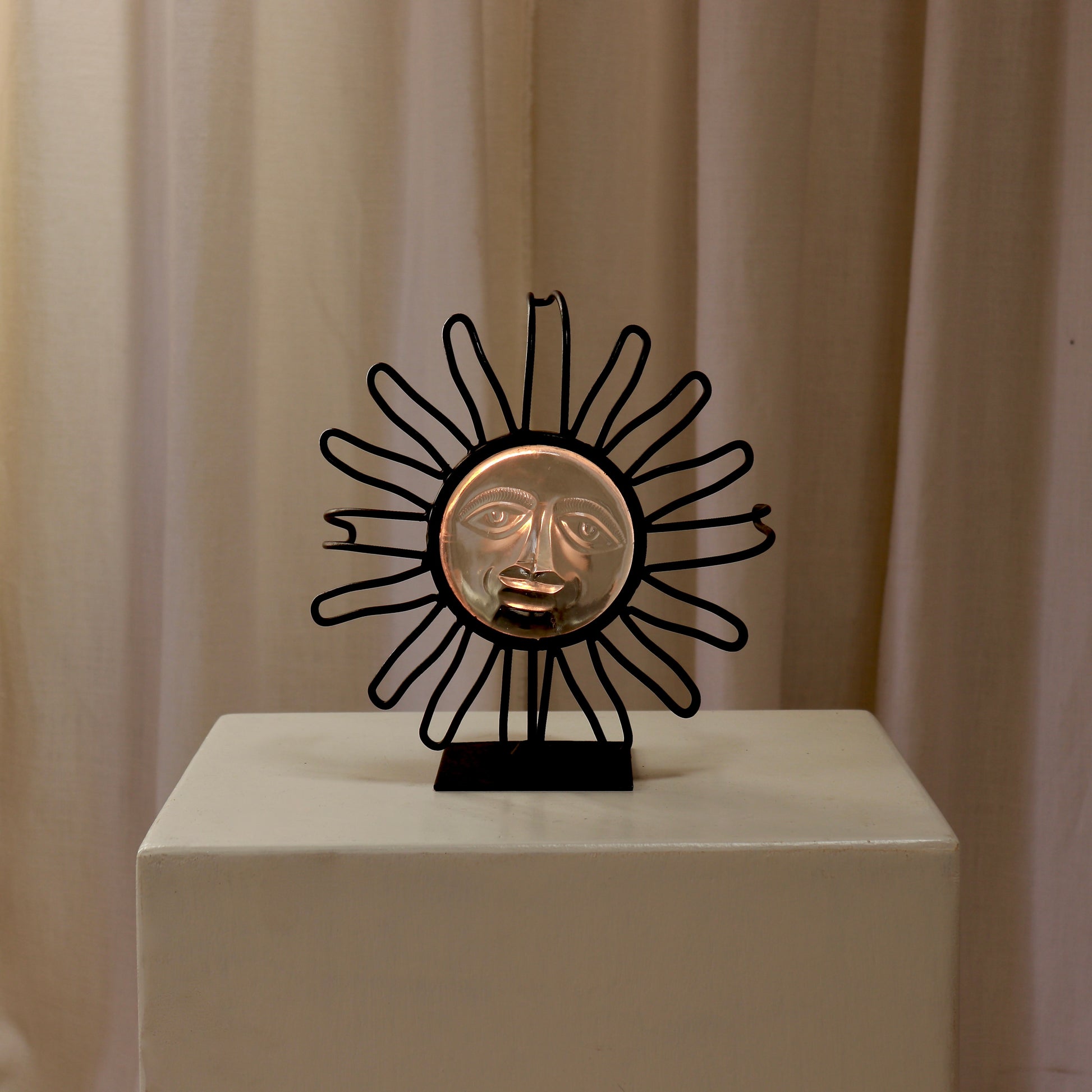 Candle-lit view showing the glass face glowing warm.