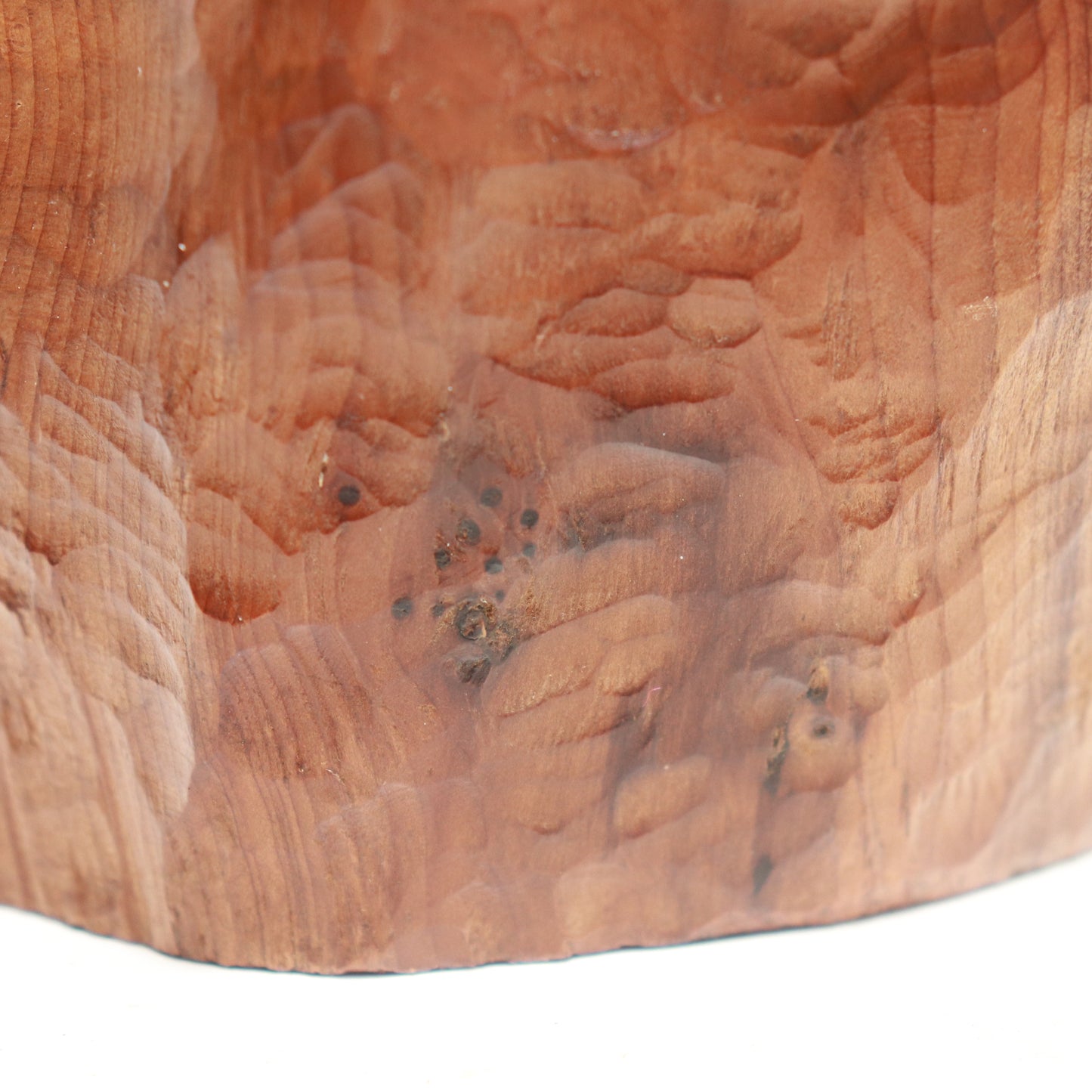 “Detail of carved surface and grain on mid-century wood sculpture”