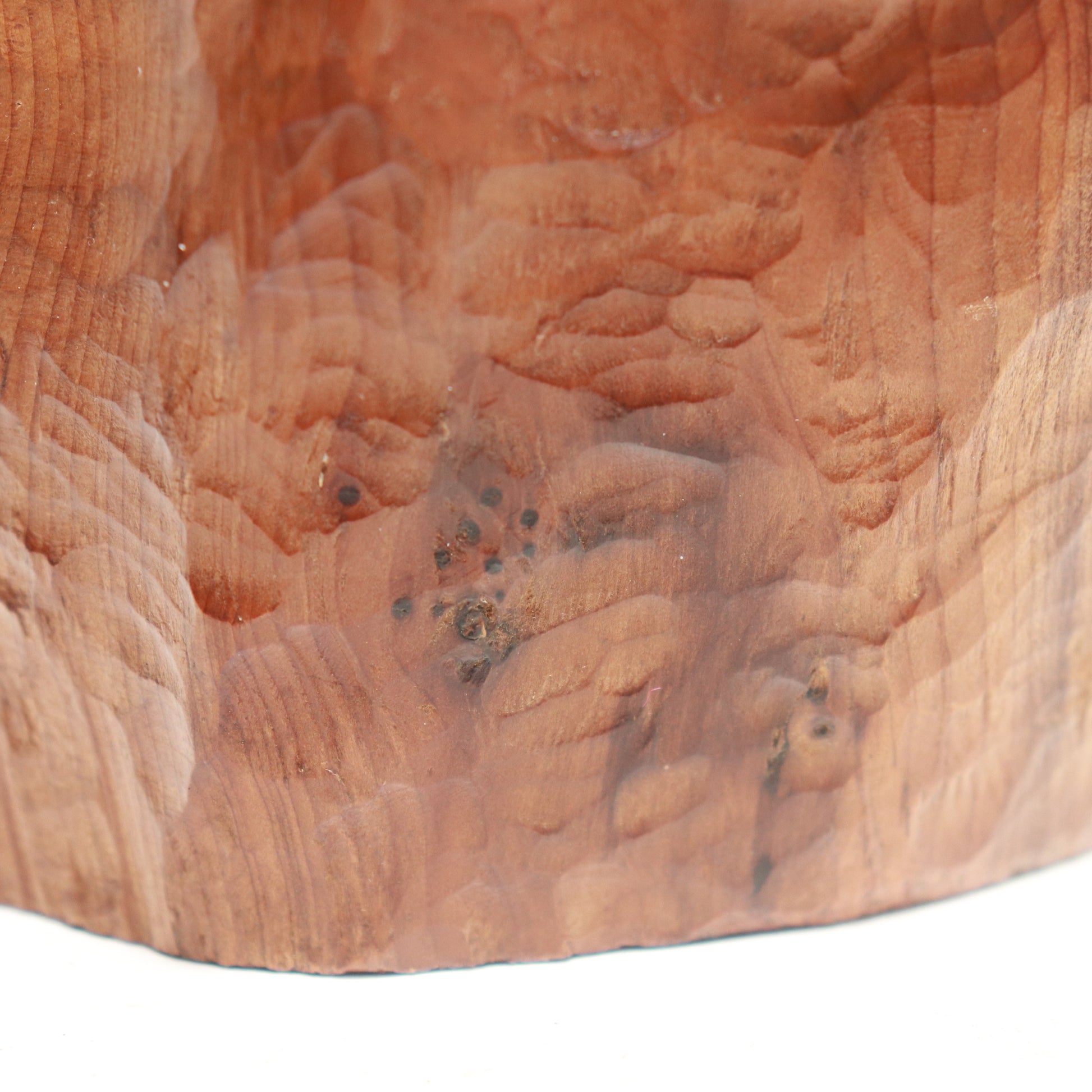 “Detail of carved surface and grain on mid-century wood sculpture”