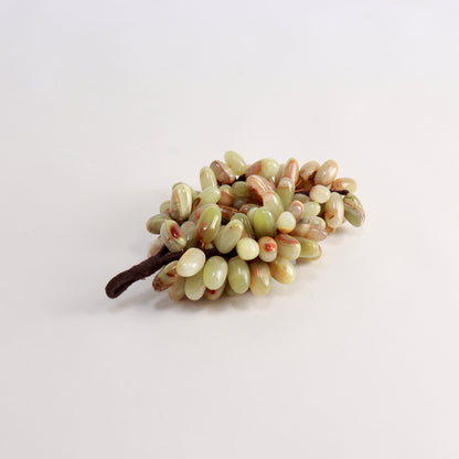 Polished banded onyx grapes with green and cream tones