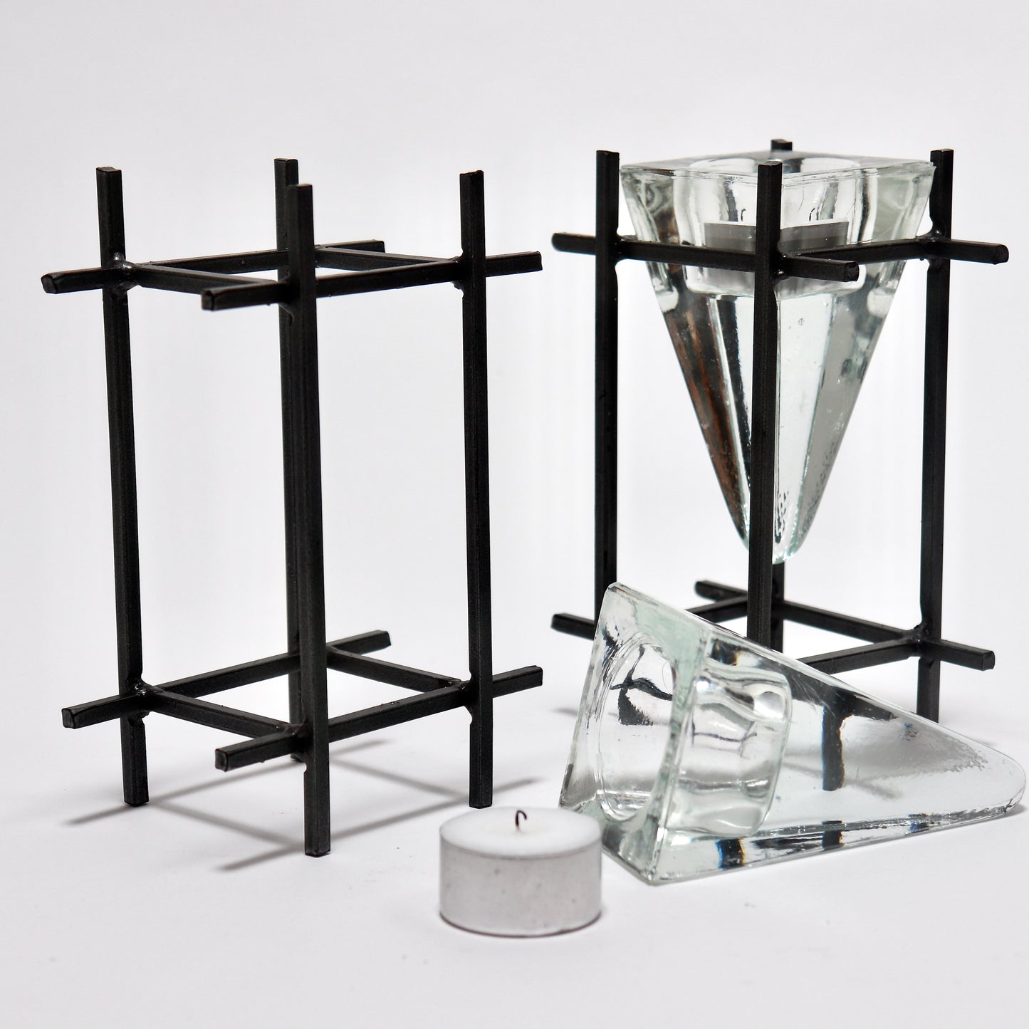 Architectural steel candle holders with glass prism inserts